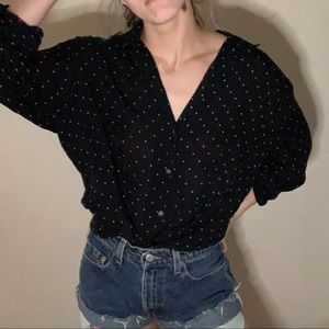 Polka dotted button down shirt.